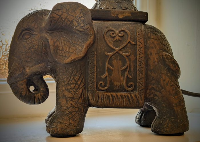 A hand carved wooden elephant lamp base